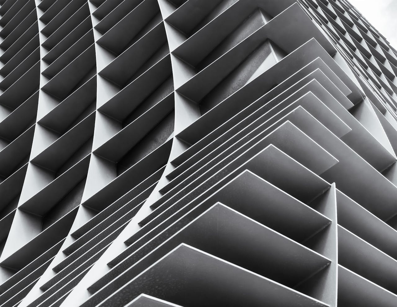 A stunning black and white image showcasing the intricate patterns of modern architecture from a unique angle.